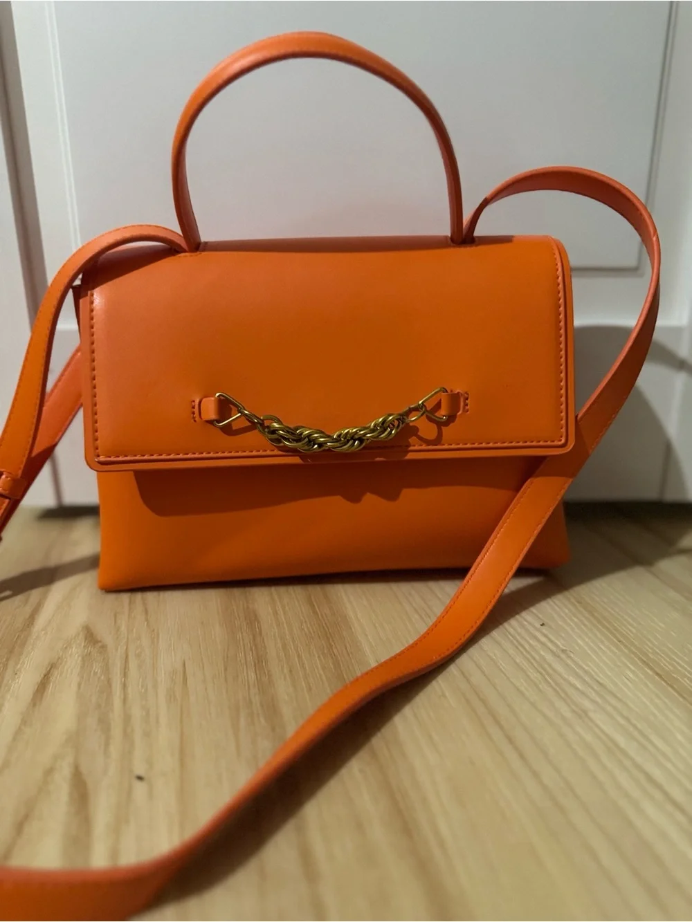 Structured Orange Leather Satchel with Gold Chain Accent
